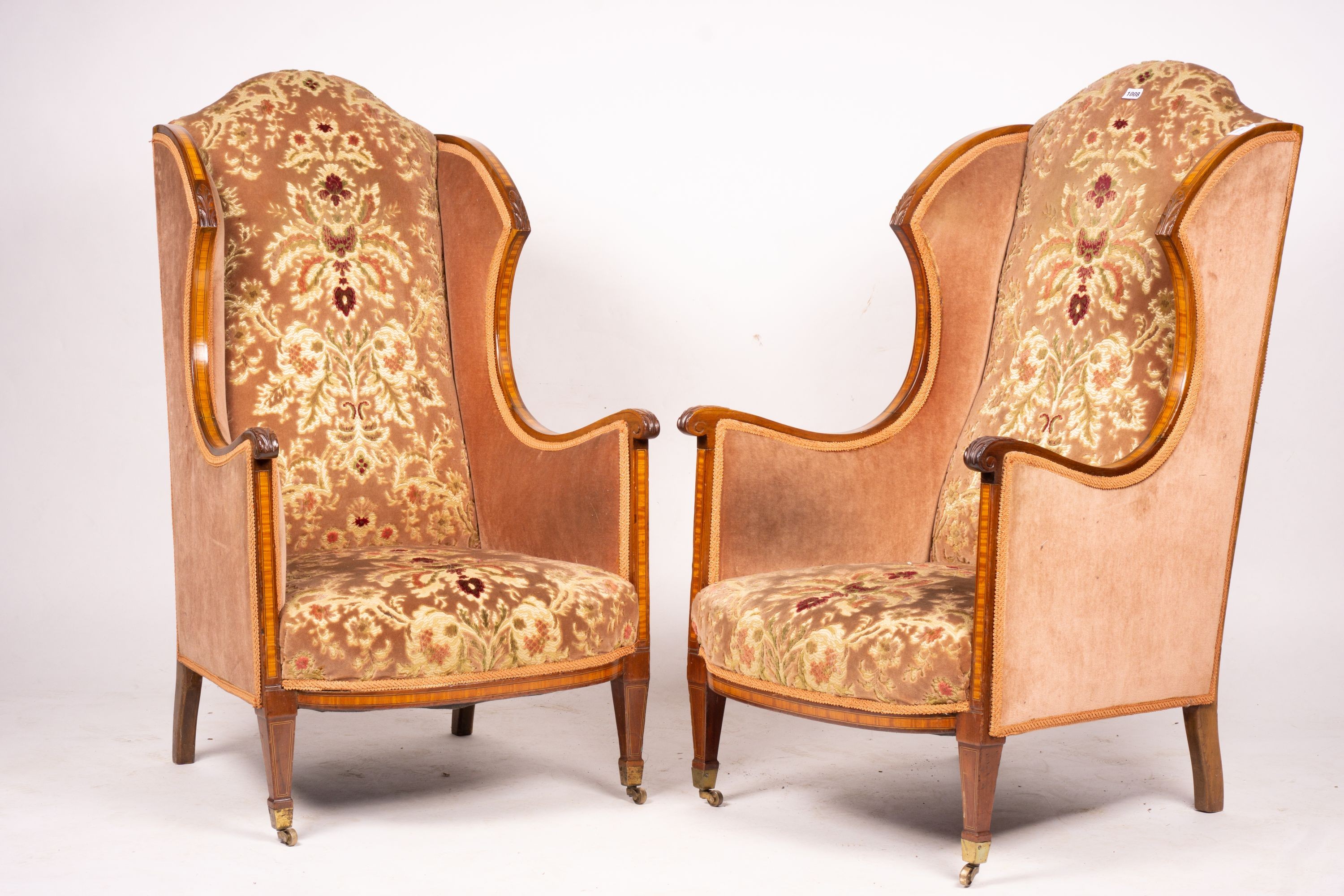 A pair of Edwardian satinwood banded mahogany wing armchairs, width 56cm, depth 75cm, height 110cm